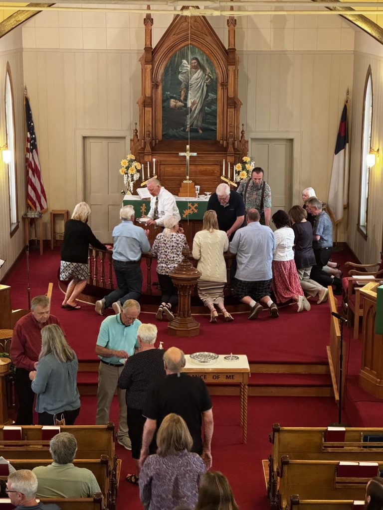 The congregation gathered for communion at the altar rail